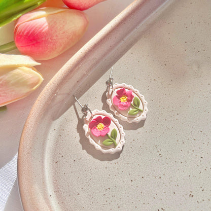 Framed Pink Flower Polymer Clay Earrings on a display dish- silverstar.nz