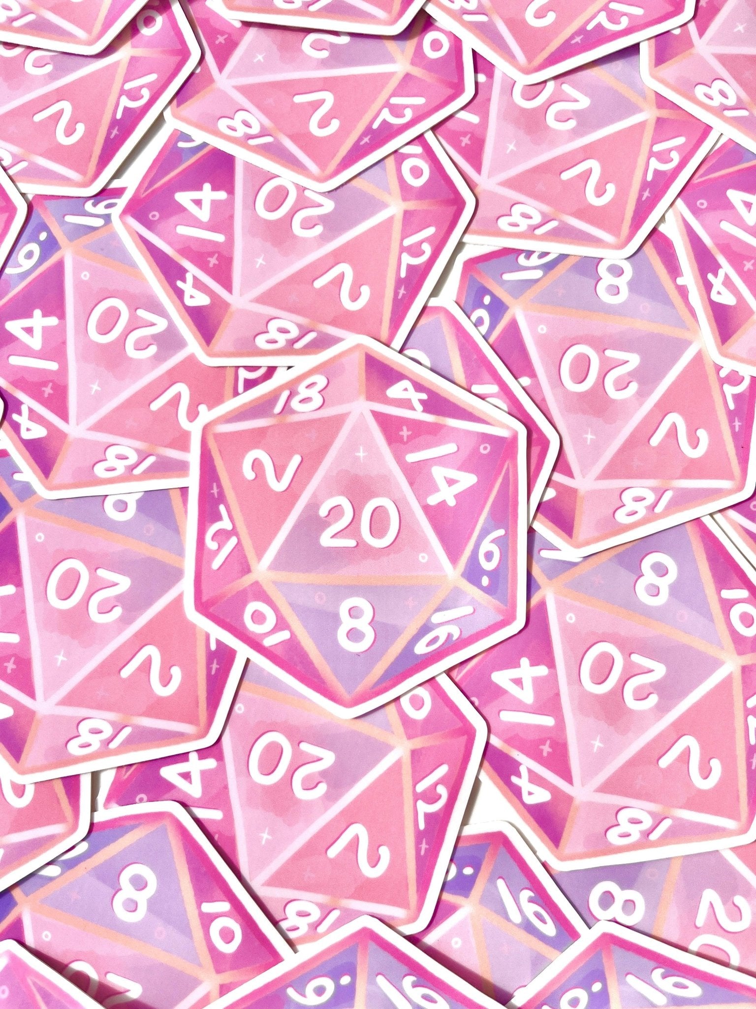 The D20 Sticker from silverstar.nz, part of the Dungeons and Dragons collection, showcases a design of overlapping pink and purple twenty-sided dice featuring white numbers, with several dice prominently highlighting the number 20. These glossy stickers have a magical allure with a starry theme and are crafted from waterproof vinyl, making them an ideal addition to any sticker assortment.